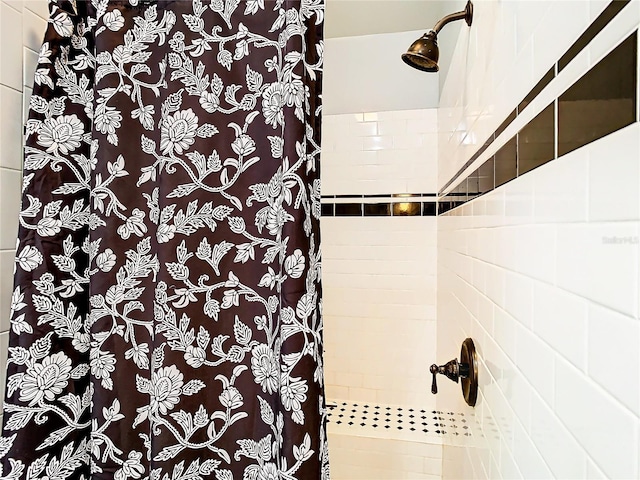 bathroom with a shower with curtain and tile walls