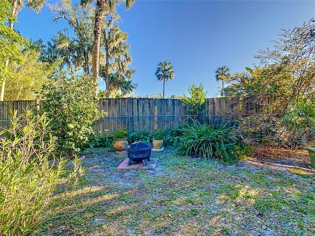 view of yard with an outdoor fire pit