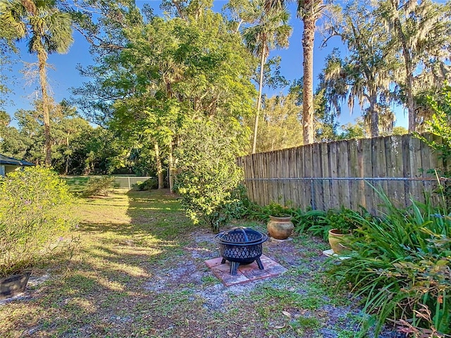 view of yard with an outdoor fire pit