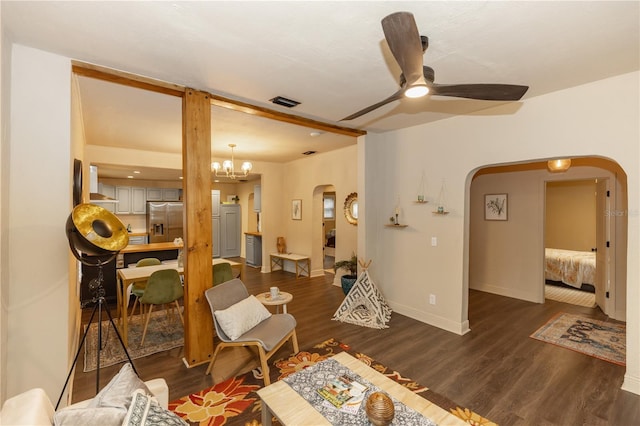 living room featuring ceiling fan with notable chandelier and dark hardwood / wood-style flooring