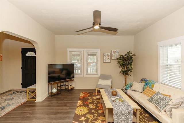 living room featuring dark hardwood / wood-style flooring and ceiling fan