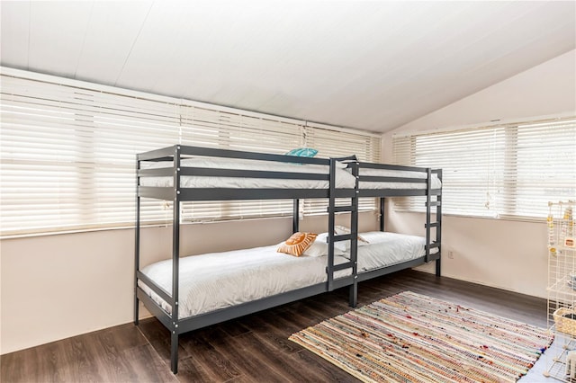 bedroom with lofted ceiling and dark wood-type flooring