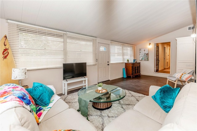 living room with dark hardwood / wood-style flooring and vaulted ceiling