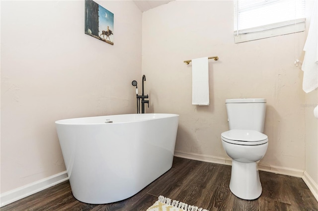 bathroom featuring a bathing tub, wood-type flooring, and toilet