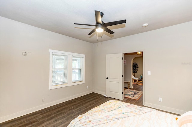 bedroom featuring ceiling fan and dark wood-type flooring