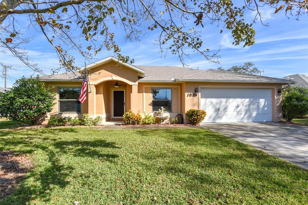 ranch-style home featuring a garage and a front lawn