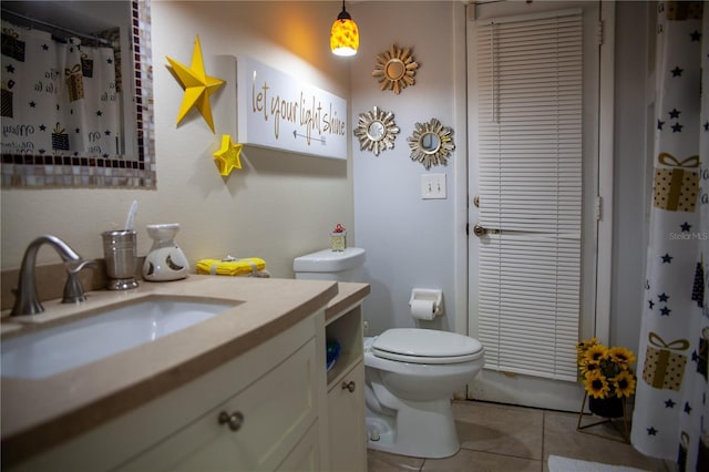 bathroom with vanity, tile patterned floors, and toilet