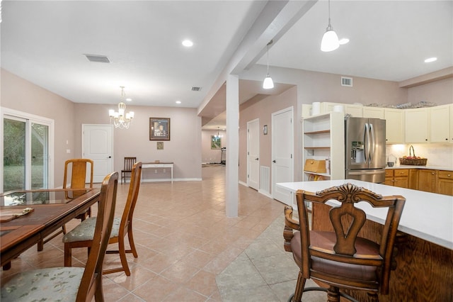 tiled dining area with an inviting chandelier