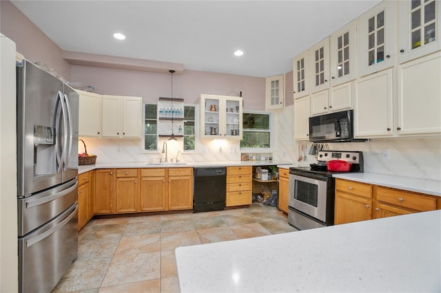 kitchen featuring sink, decorative light fixtures, backsplash, and black appliances