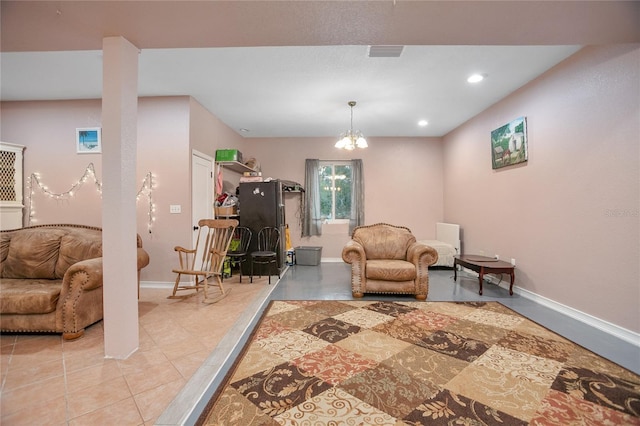 living area featuring light tile patterned floors and a chandelier