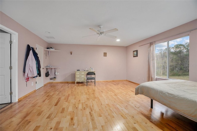 bedroom with ceiling fan and light wood-type flooring