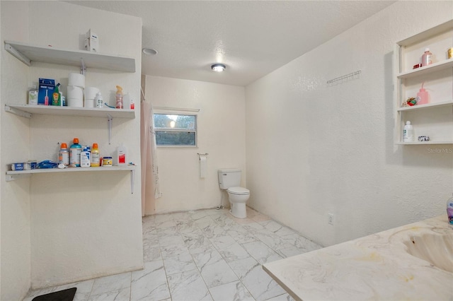 bathroom with vanity, a textured ceiling, and toilet