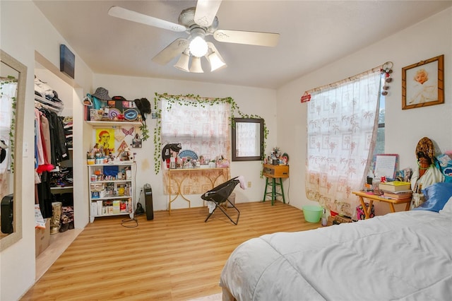 bedroom featuring hardwood / wood-style floors, a closet, and ceiling fan