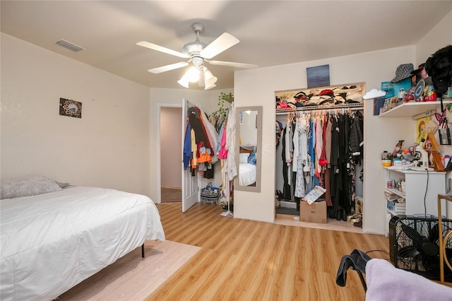 bedroom with wood-type flooring, a closet, and ceiling fan