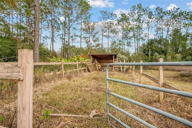 view of gate featuring an outdoor structure