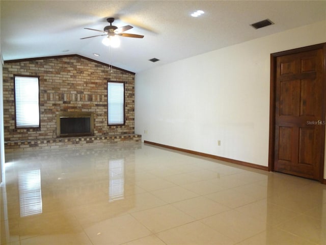 unfurnished living room with visible vents, a ceiling fan, baseboards, light tile patterned floors, and lofted ceiling