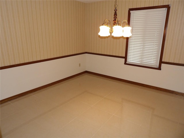 unfurnished room with tile patterned floors, baseboards, an inviting chandelier, and wallpapered walls