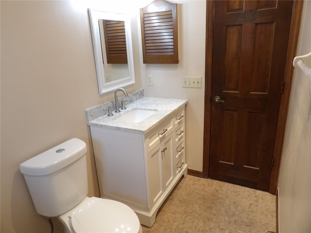 bathroom featuring toilet and vanity