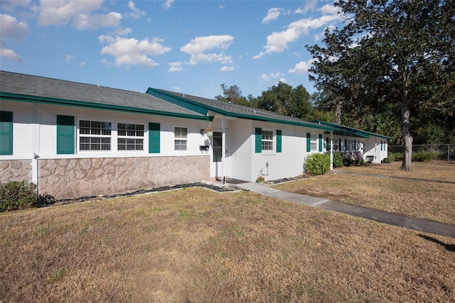 ranch-style home with a front lawn