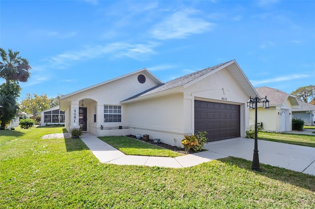 ranch-style house with driveway, a front lawn, an attached garage, and stucco siding