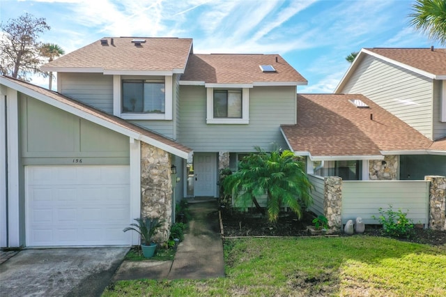 view of front of house with a garage and a front lawn