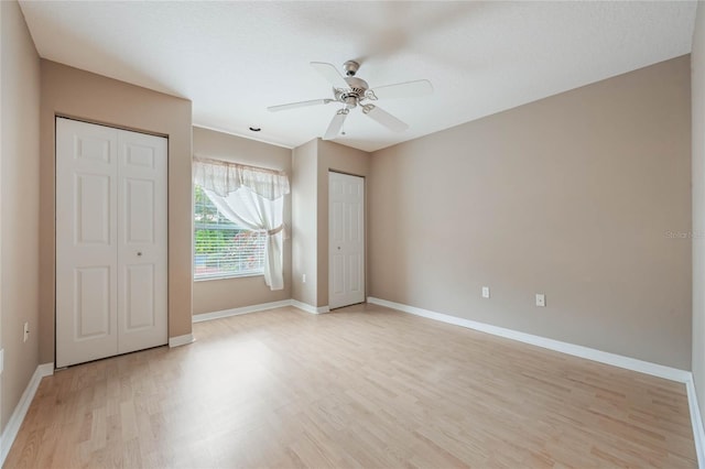 unfurnished bedroom featuring a textured ceiling, light hardwood / wood-style flooring, and ceiling fan