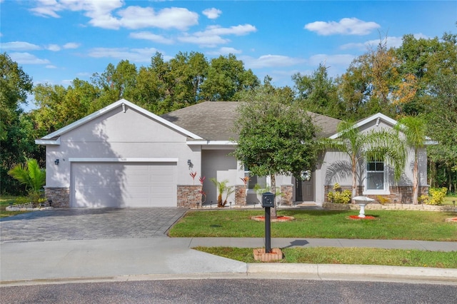 ranch-style home with stucco siding, stone siding, decorative driveway, a front lawn, and a garage