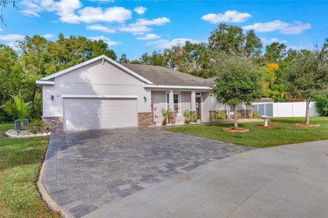 ranch-style home with a garage and a front yard