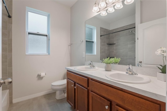 bathroom with toilet, vanity, and tile patterned floors