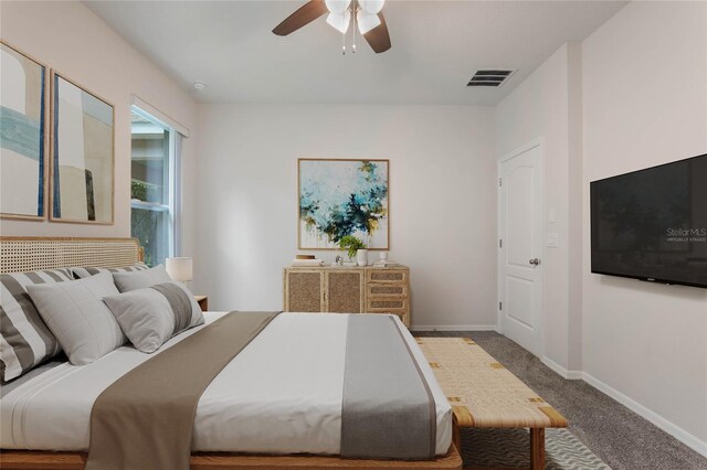 carpeted bedroom featuring visible vents, baseboards, and a ceiling fan