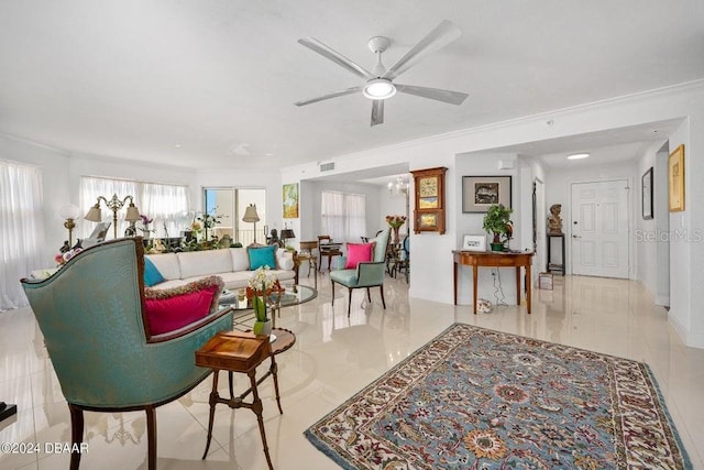 tiled living room featuring ceiling fan and crown molding