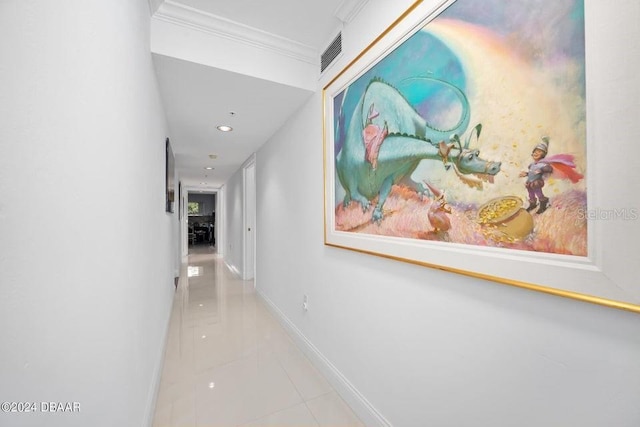 corridor with light tile patterned floors and crown molding