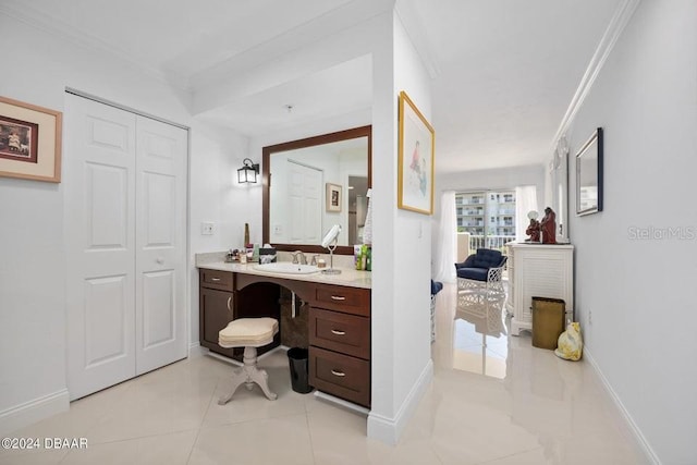 bathroom featuring tile patterned floors, crown molding, and vanity