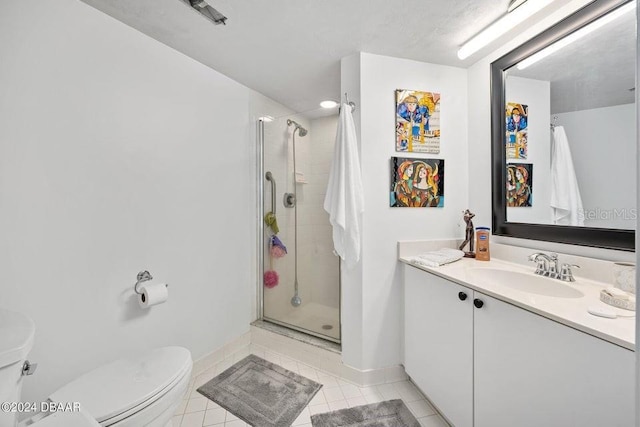 bathroom featuring toilet, vanity, tile patterned floors, and walk in shower