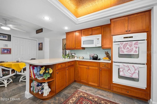 kitchen with backsplash, ceiling fan, white appliances, and kitchen peninsula