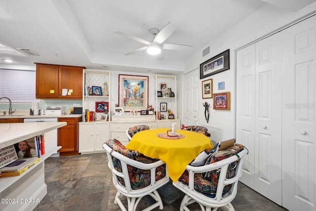 dining room featuring ceiling fan and sink