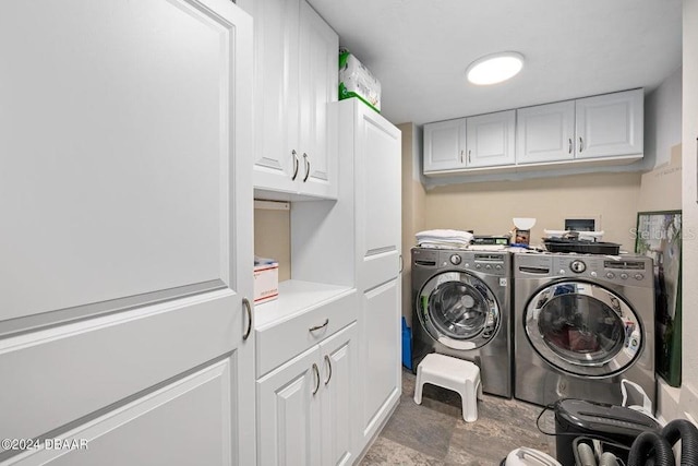 laundry room with separate washer and dryer and cabinets