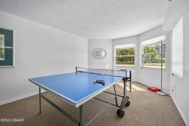 playroom with light carpet and a textured ceiling