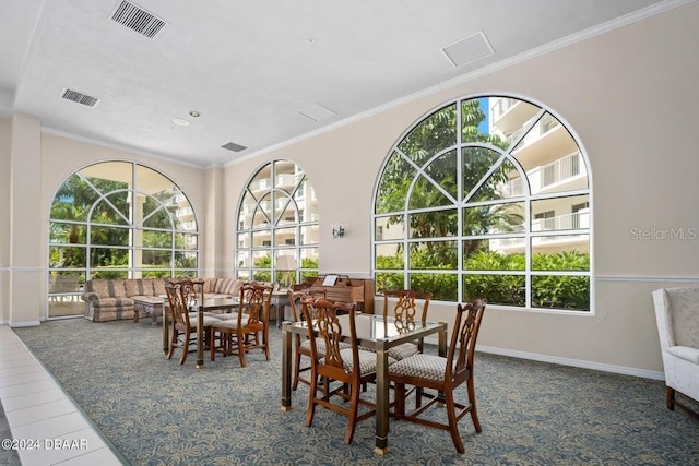 dining room featuring crown molding