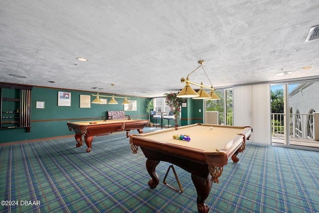 game room with a textured ceiling and pool table