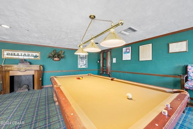 recreation room with a textured ceiling, ornamental molding, and pool table