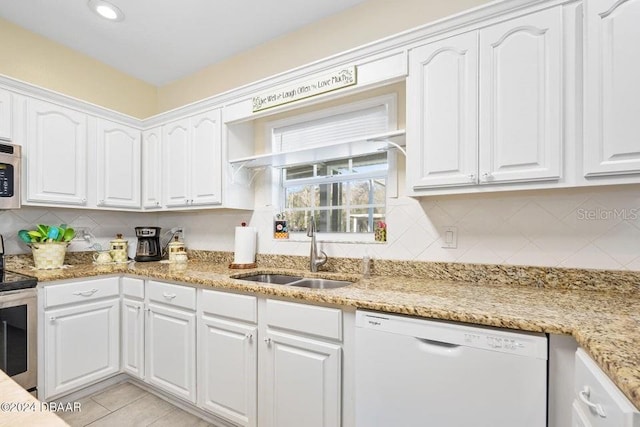 kitchen featuring sink, white cabinets, white dishwasher, and electric stove