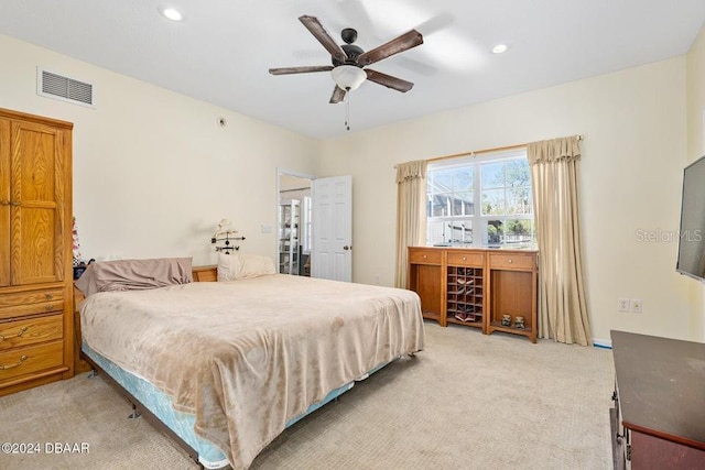 bedroom with light carpet and ceiling fan