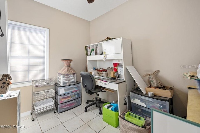 tiled home office featuring ceiling fan