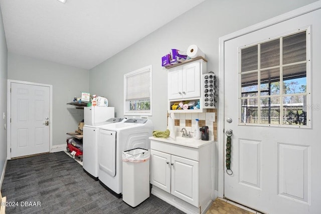 laundry area featuring cabinets, a healthy amount of sunlight, washing machine and dryer, and dark colored carpet