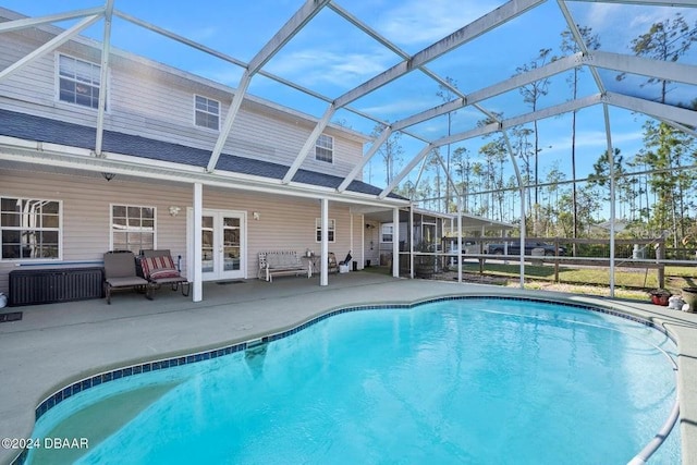 view of pool with french doors, an outdoor living space, a lanai, and a patio