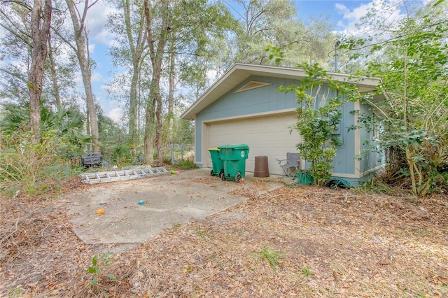 view of home's exterior with a garage and an outdoor structure