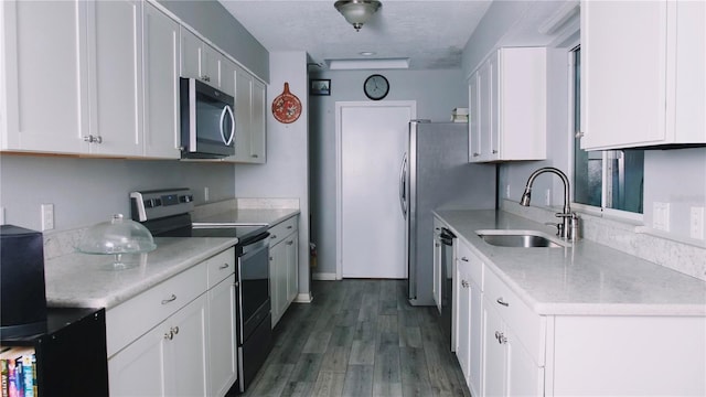 kitchen featuring sink, white cabinets, dark hardwood / wood-style floors, and appliances with stainless steel finishes