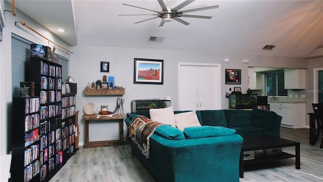 living room featuring ceiling fan and light hardwood / wood-style flooring