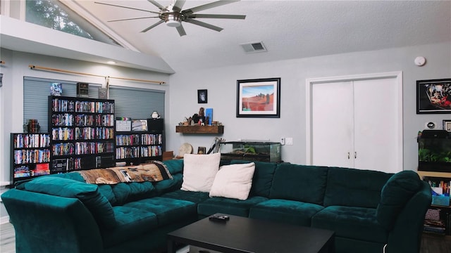 living room featuring ceiling fan, a textured ceiling, and high vaulted ceiling